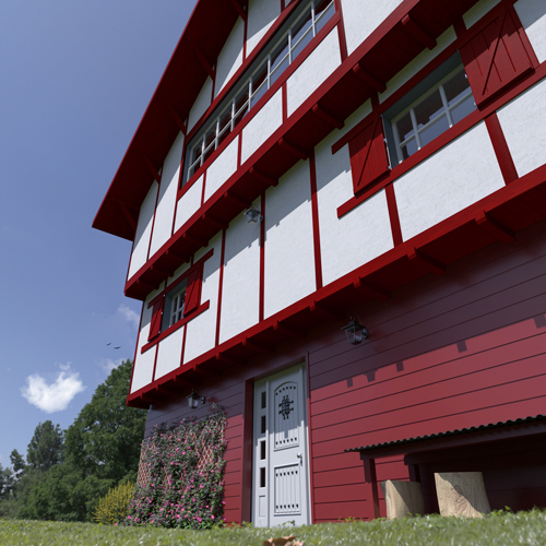 Réalisation du bardage Isocel Premium unis de couleur rouge basque sur une maison traditionnel basque